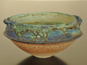 Late 80's/early 90's. Barium and copper glazes. Heavily grogged (molochite) white stoneware bowl with handles.