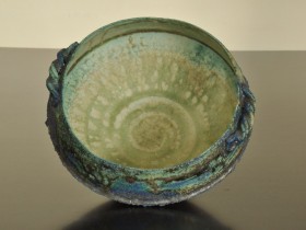 Late 80's/early 90's. Barium and copper glazes. Heavily grogged (molochite) white stoneware bowl with handles.