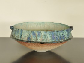 Late 80's/early 90's. Barium and copper glazes. Heavily grogged (molochite) white stoneware bowl with handles.